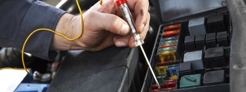Auto electrician working on a vehicle